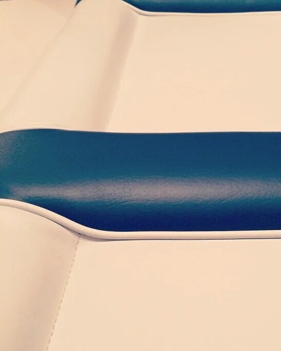 Restored vintage wooden motor launch with new cream upholstery